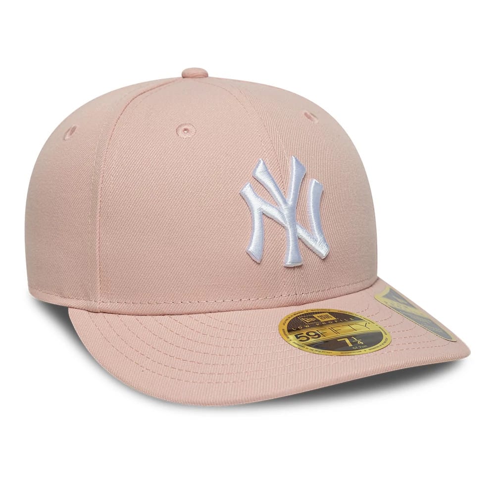 New York Yankees MLB Pastel Pink Low Profile New Era 59FIFTY Fitted Cap, three-quarter view showing a raised white NY logo on the front panel, a gold 59FIFTY size sticker on the curved pastel pink visor, and eyelets on the crown.