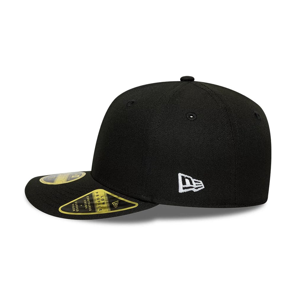 New Era Black Low Profile 59FIFTY Fitted Cap, side view showing the white embroidered New Era flag logo on the left side of the black structured crown, with a flat black visor featuring a gold 59FIFTY size sticker on top.