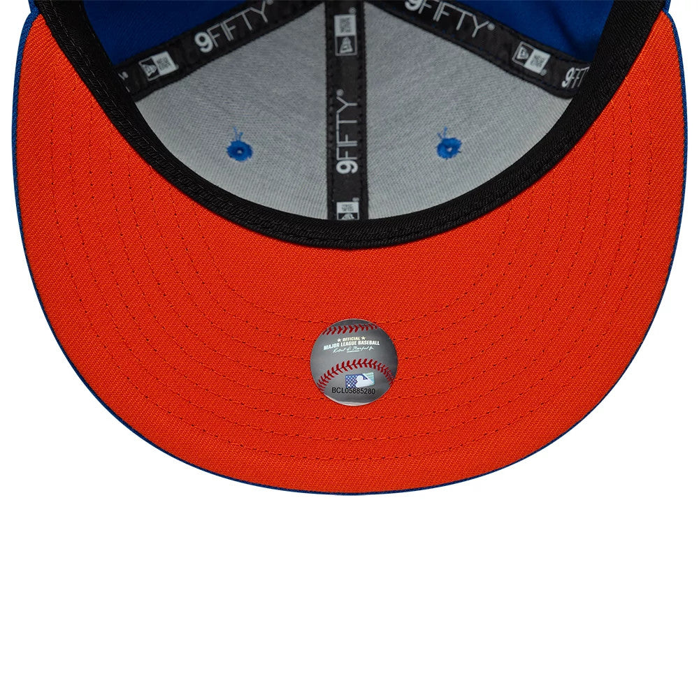 New York Mets MLB Upside Down Blue New Era 9FIFTY Snapback Cap, inside view displaying a black sweatband with New Era branding, grey undervisor with blue eyelets, and an MLB authenticity sticker on the orange visor.