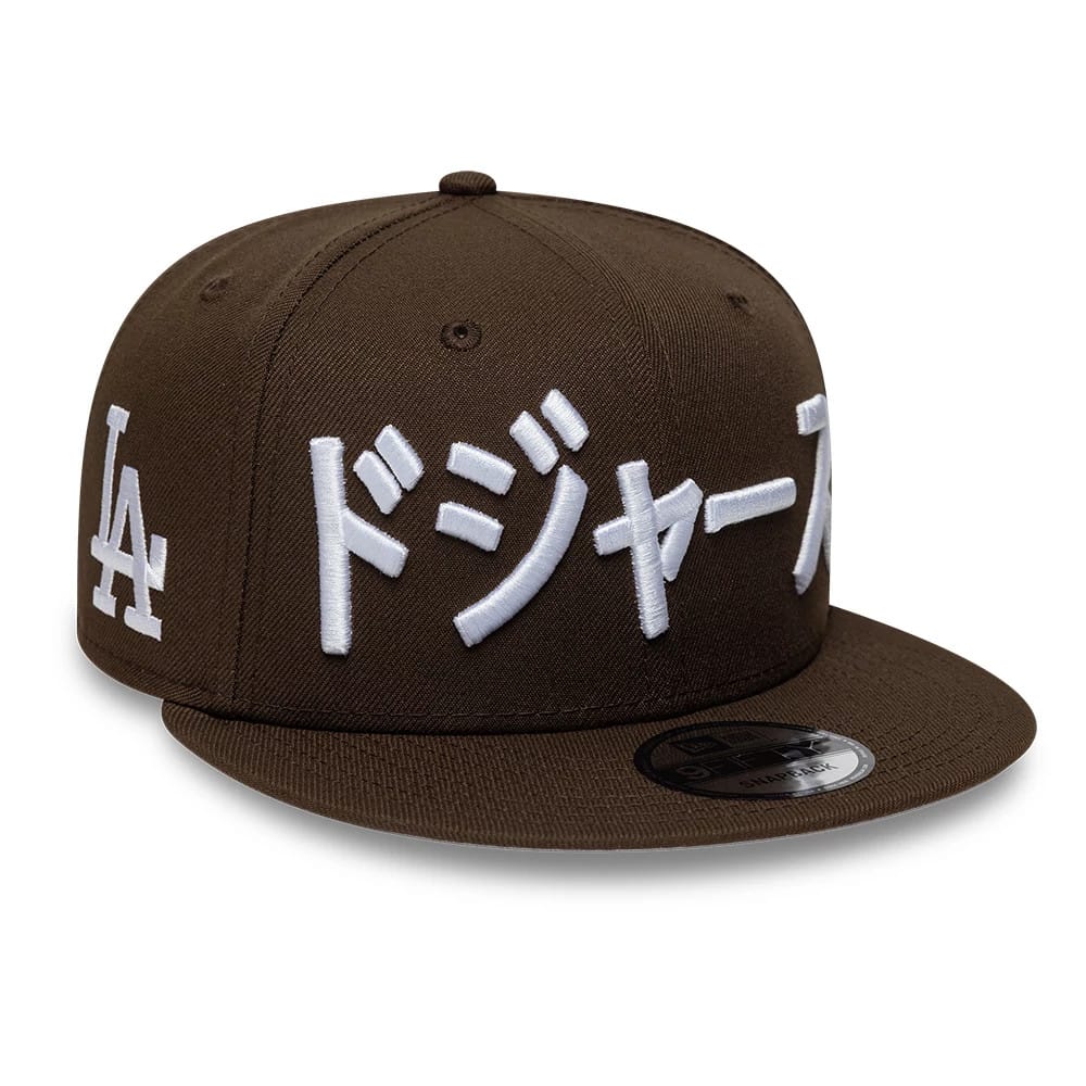 Pictured is this MLB Kanji LA Dodgers 9FIFTY Snapback Adjustable cap in dark brown. 1