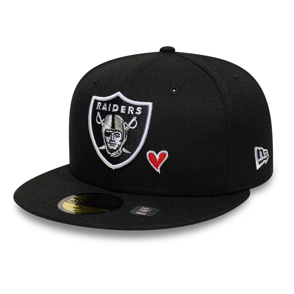 Las Vegas Raiders NFL Heart Black New Era 59FIFTY Fitted Cap, front view showing the raised embroidered team shield logo on the front panel with a red heart to its right, a curved black visor and a gold 59FIFTY size sticker.