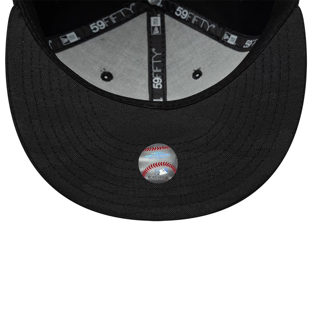 LA Dodgers MLB Camo Black New Era 59FIFTY Fitted Cap, inside view showing the grey undervisor with embroidered eyelets, black taping with white 59FIFTY branding, and a black sweatband, featuring a baseball-themed sticker underneath the visor.