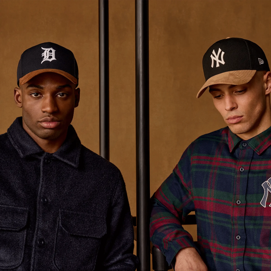 Slide 1:Two men wearing baseball caps against a brown background