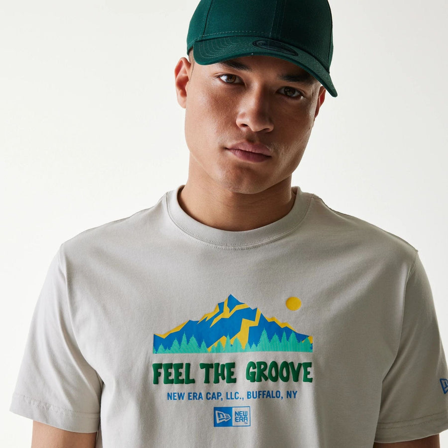The Male model is wearing New Era Outdoor Earth Day Stone Side Pocket T-Shirt 3