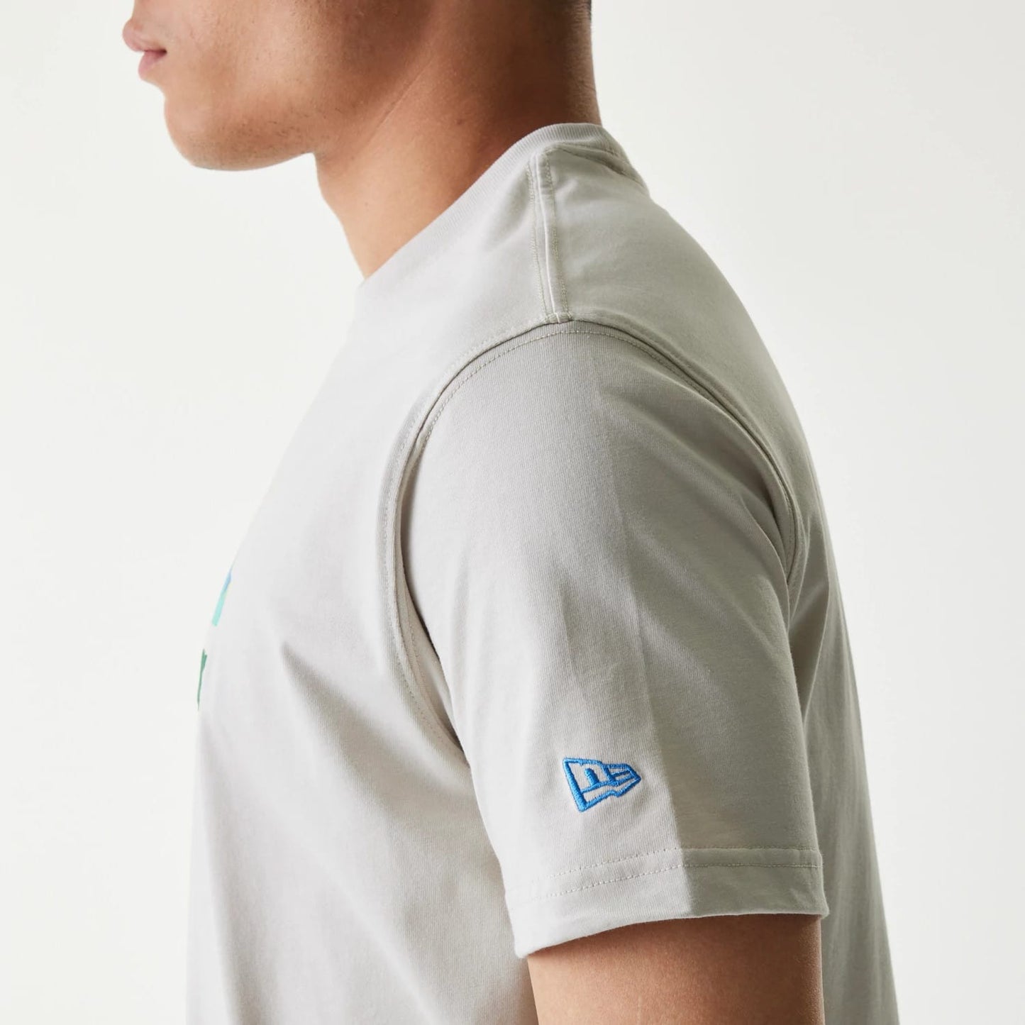 The Male model is wearing New Era Outdoor Earth Day Stone Side Pocket T-Shirt 5