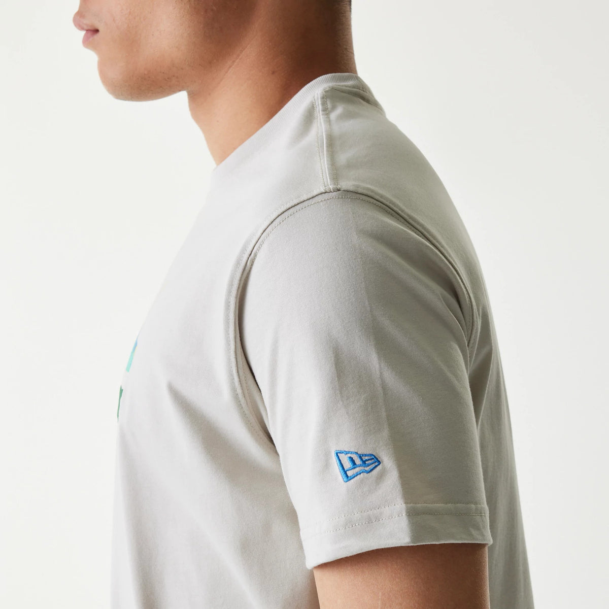 The Male model is wearing New Era Outdoor Earth Day Stone Side Pocket T-Shirt 5