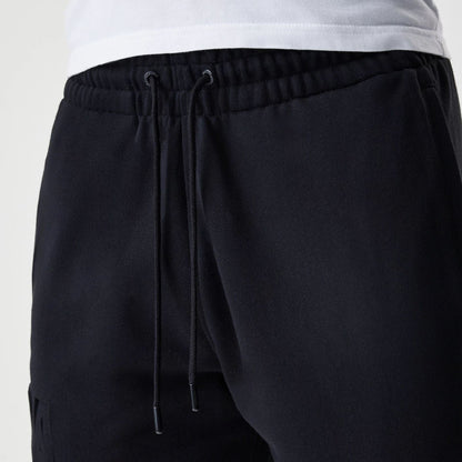The Male model is wearing New Era Tonal Pack Black Shorts 5