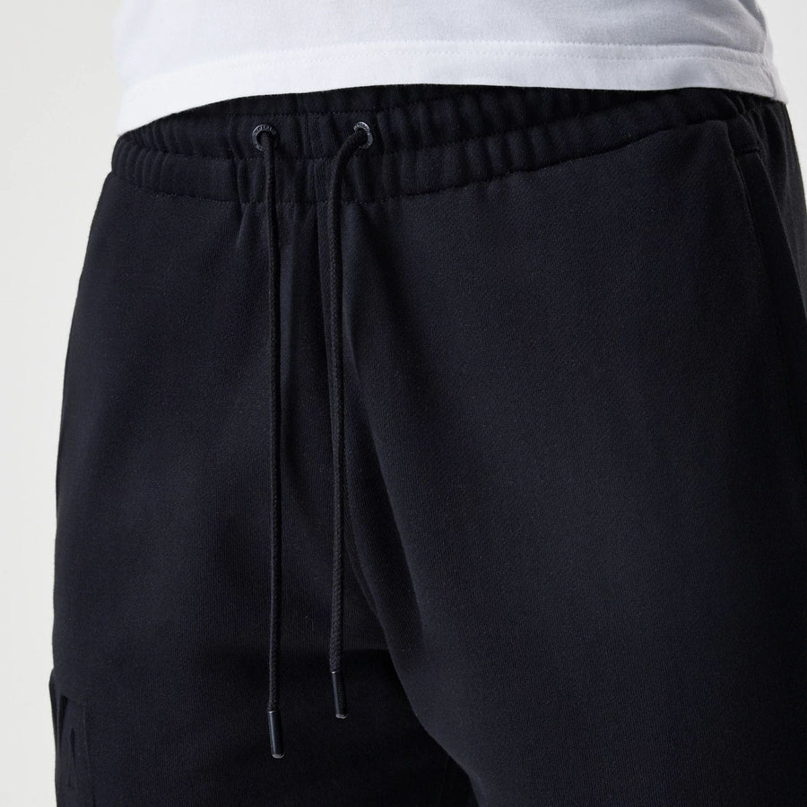 The Male model is wearing New Era Tonal Pack Black Shorts 5