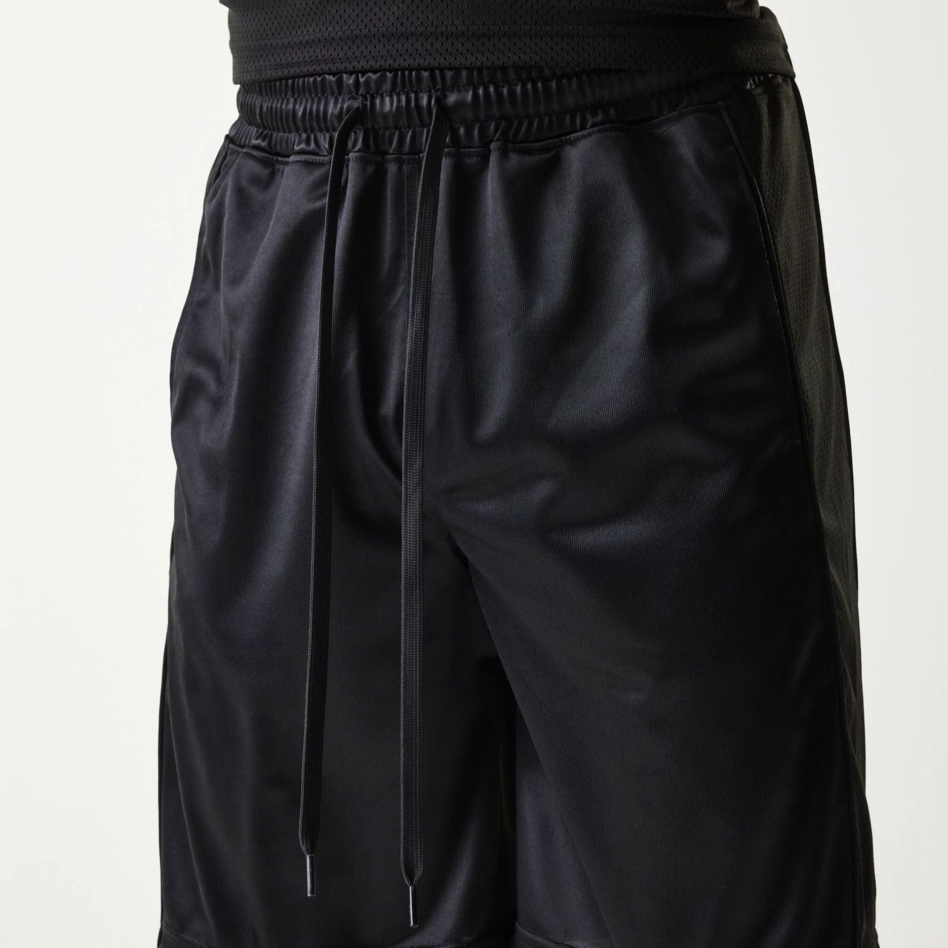 The Male model is wearing New Era Retro Sports Black Mesh Shorts 3