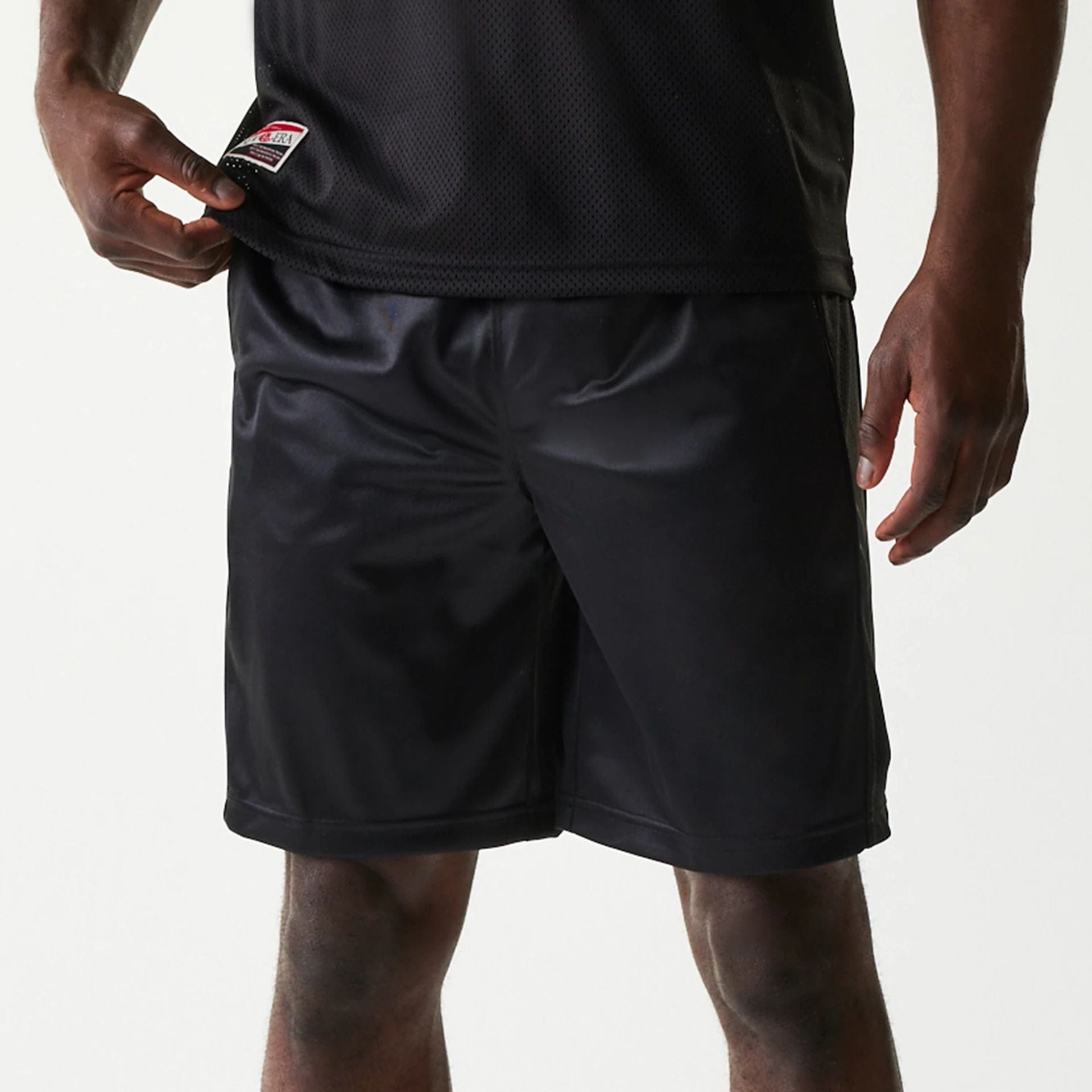 The Male model is wearing New Era Retro Sports Black Mesh Shorts 8