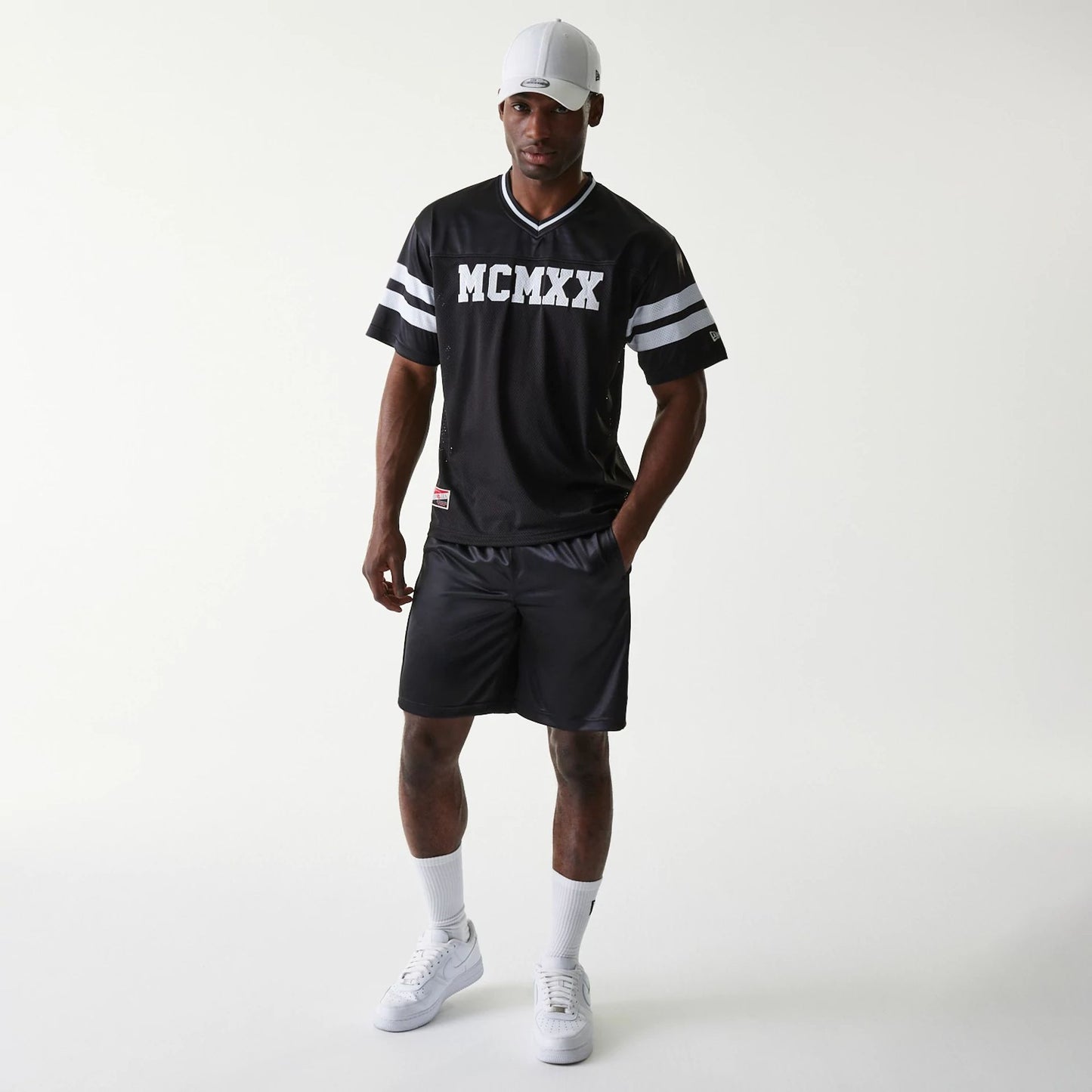 The Male model is wearing New Era Retro Sports Black Mesh Shorts 6