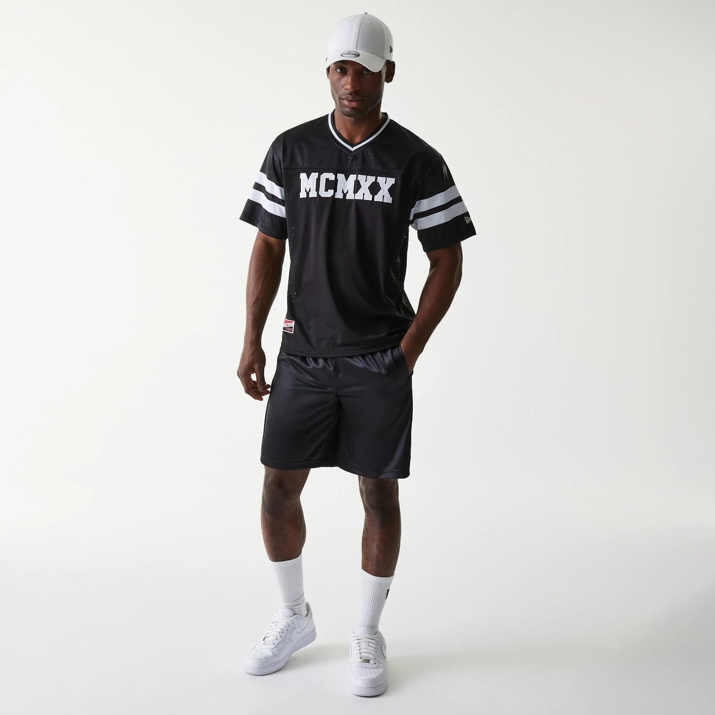 The Male model is wearing New Era Retro Sports Black Mesh Shorts 6