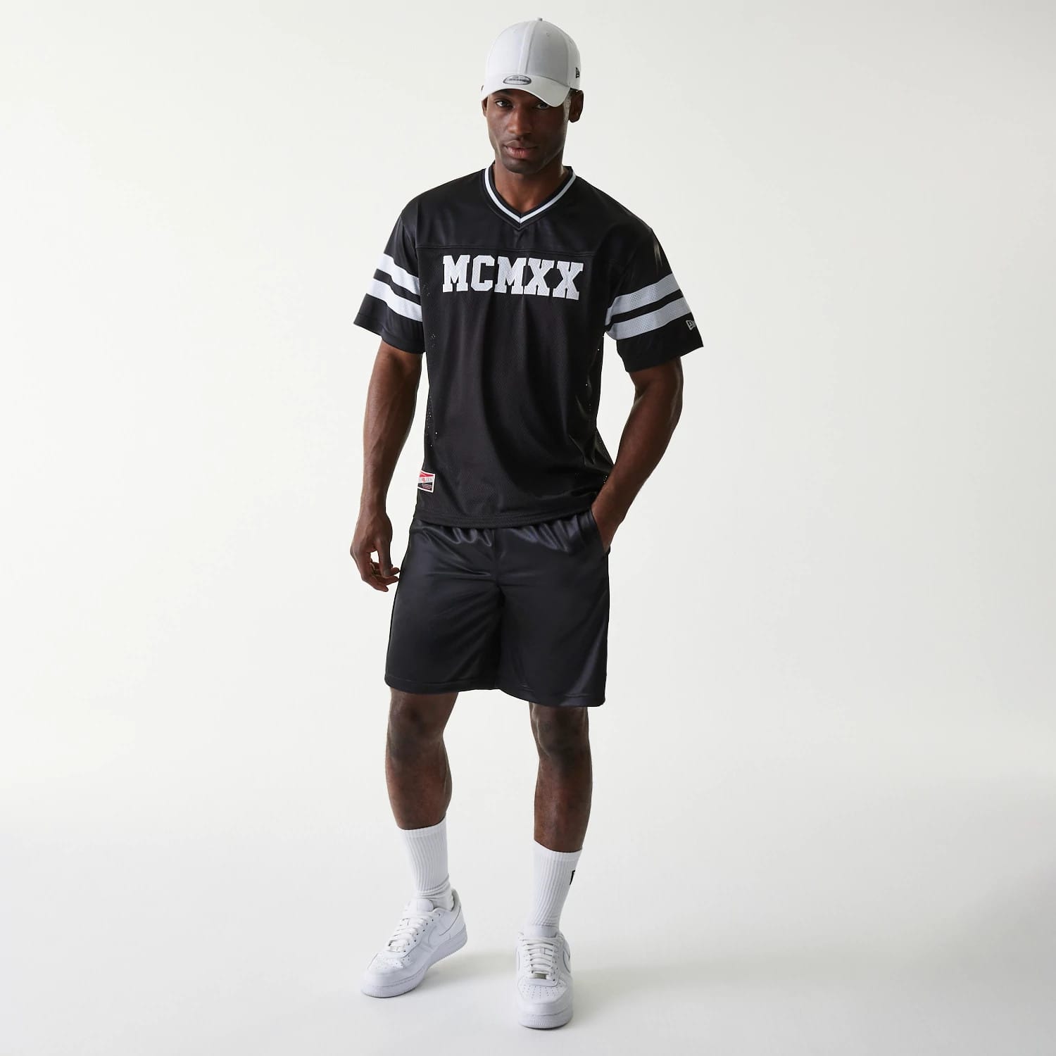 The Male model is wearing New Era Retro Sports Black Mesh Shorts 6
