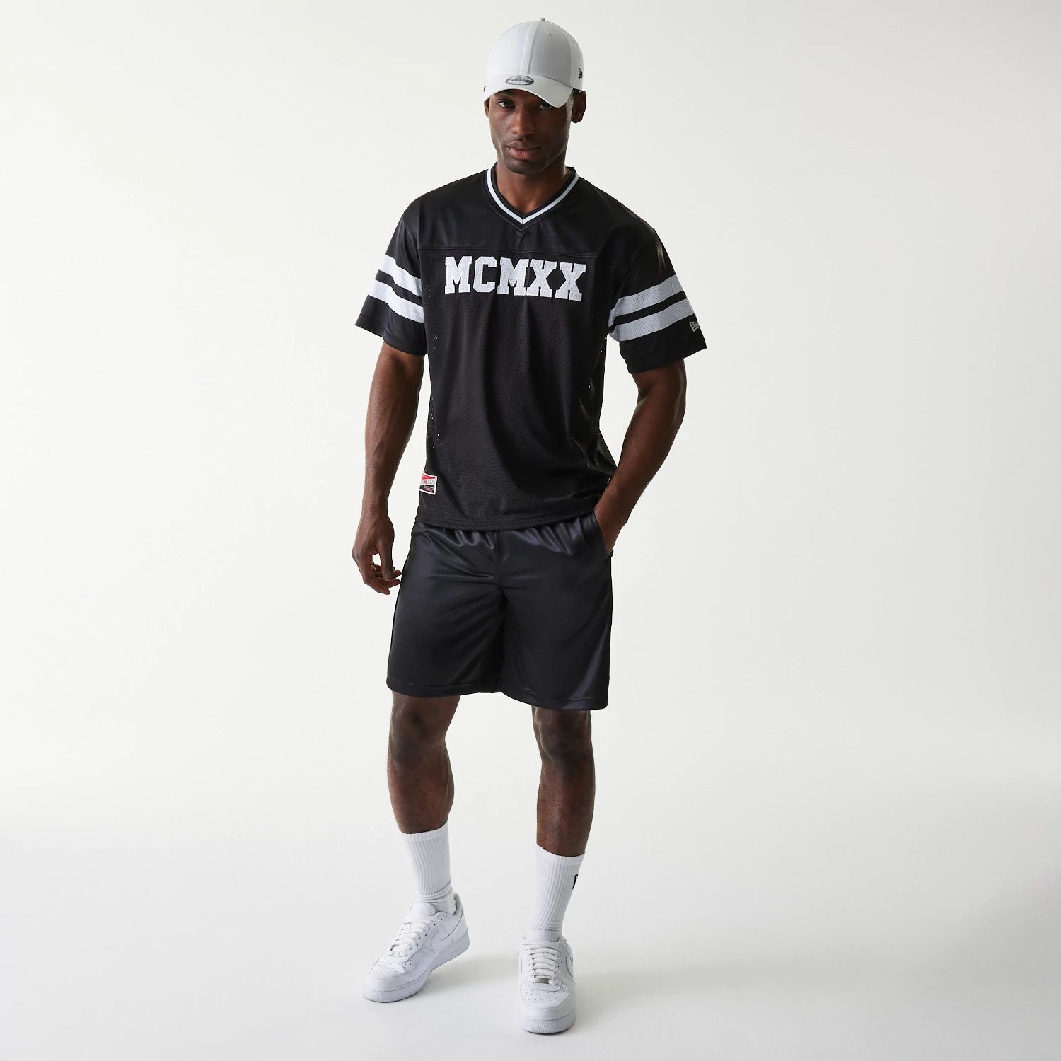 The Male model is wearing New Era Retro Sports Black Mesh Shorts 6