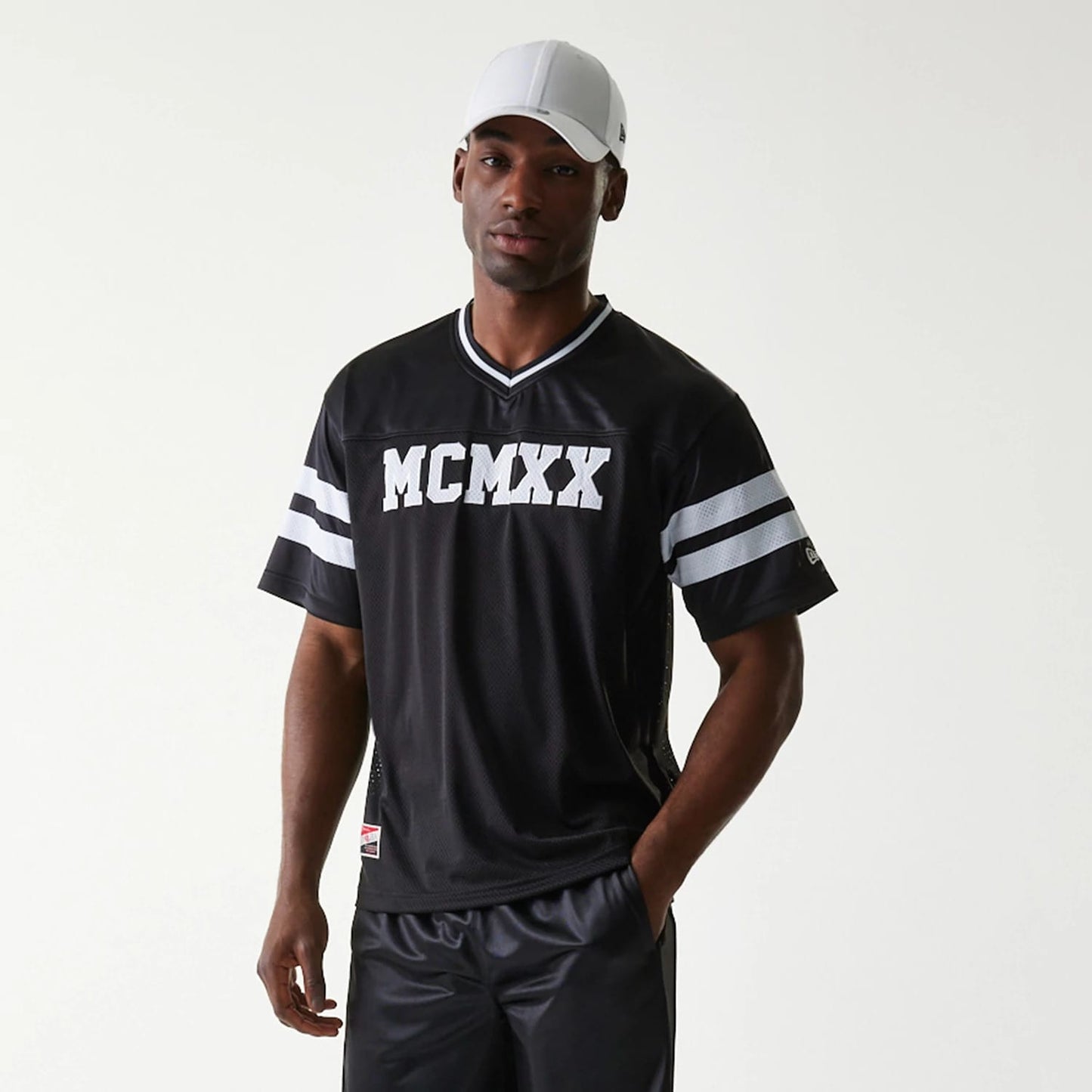 The Male model is wearing New Era Retro Sports Black Mesh Jersey 7