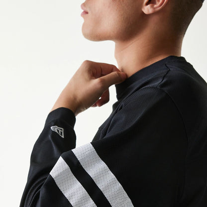 The Male model is wearing New Era Mesh Water Black Long Sleeve T-Shirt 7