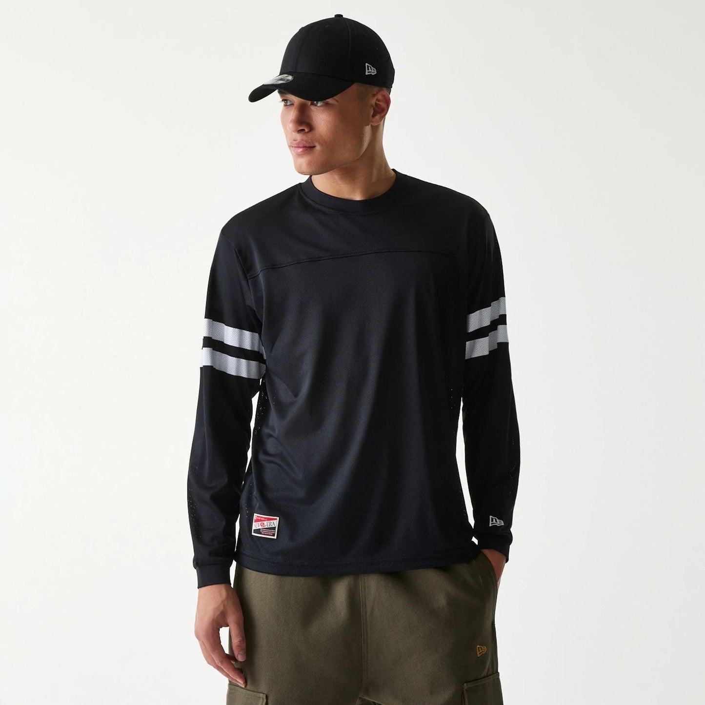 The Male model is wearing New Era Mesh Water Black Long Sleeve T-Shirt 1