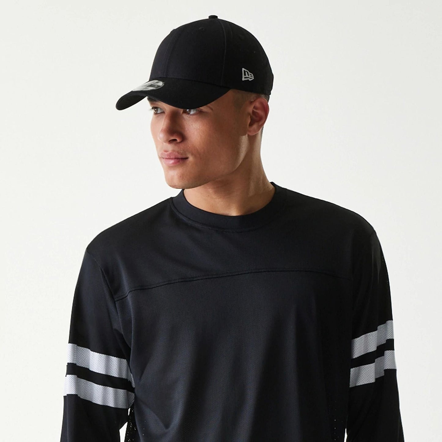 The Male model is wearing New Era Mesh Water Black Long Sleeve T-Shirt 6