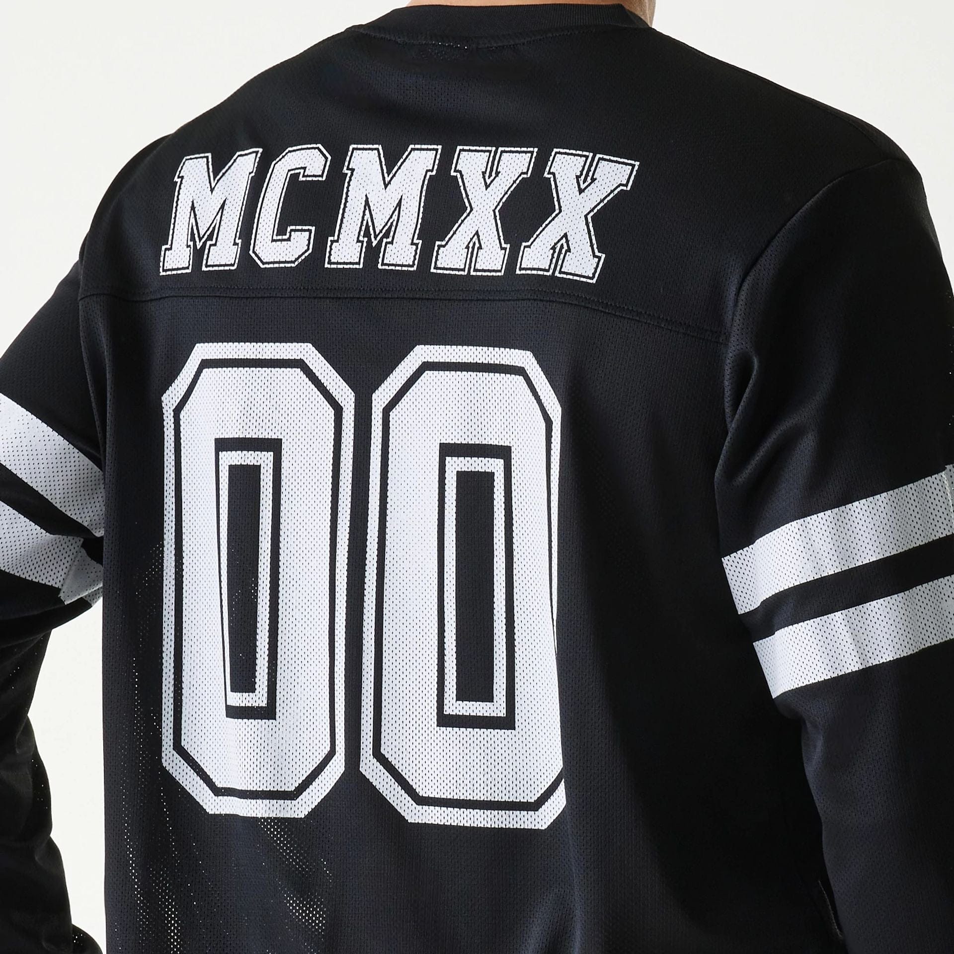 The Male model is wearing New Era Mesh Water Black Long Sleeve T-Shirt 4