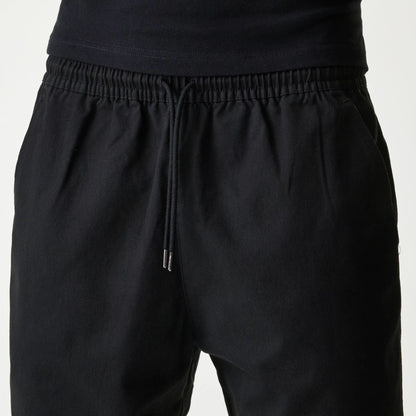 The Male model is wearing New Era Japan Woven Black Shorts 4