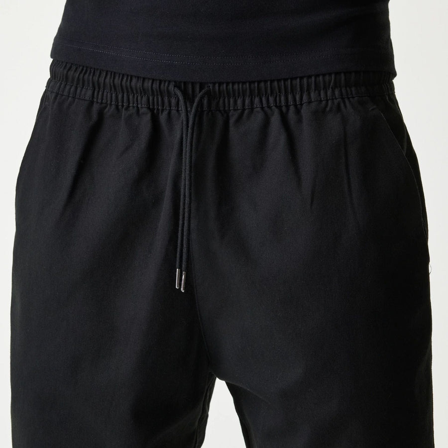The Male model is wearing New Era Japan Woven Black Shorts 4