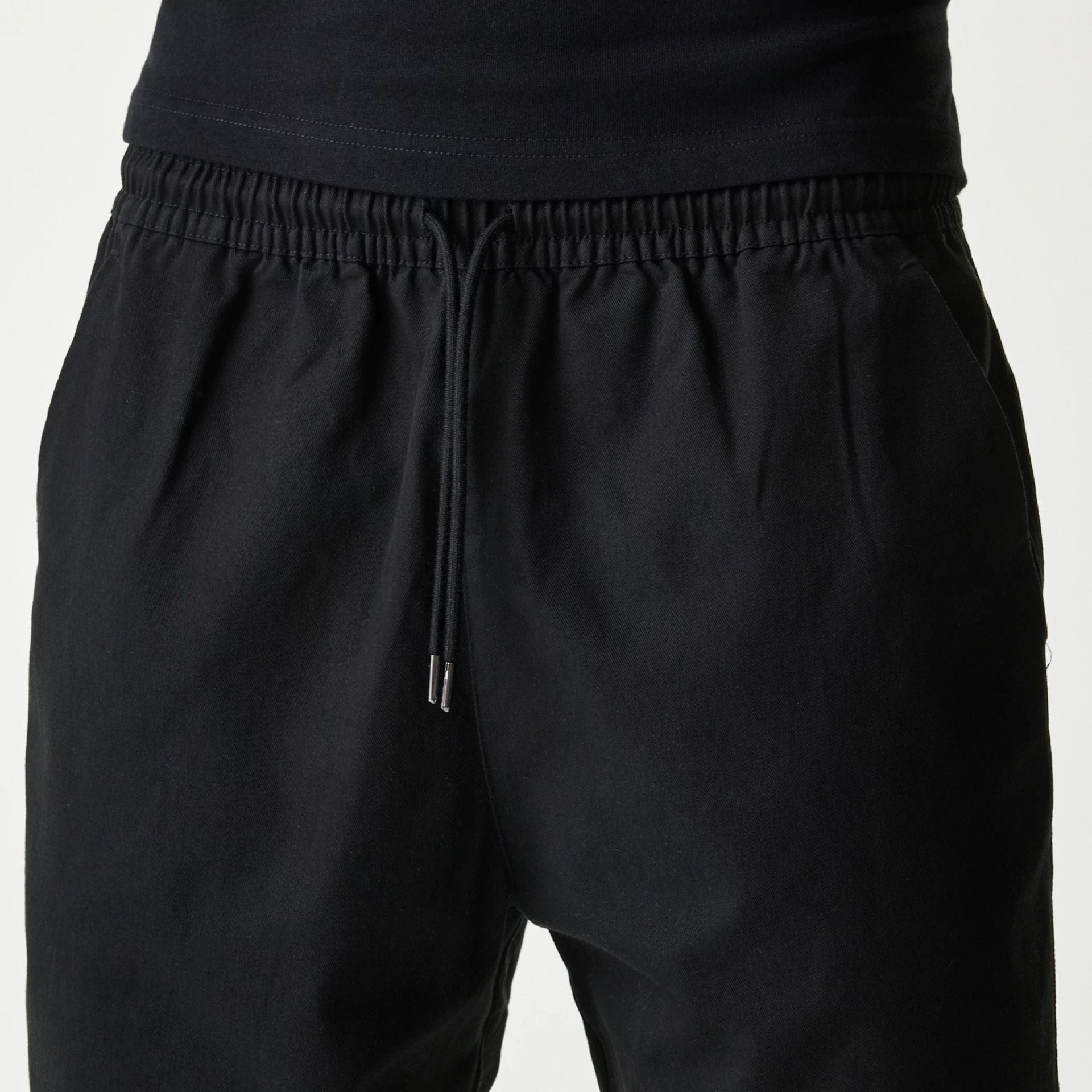 The Male model is wearing New Era Japan Woven Black Shorts 4