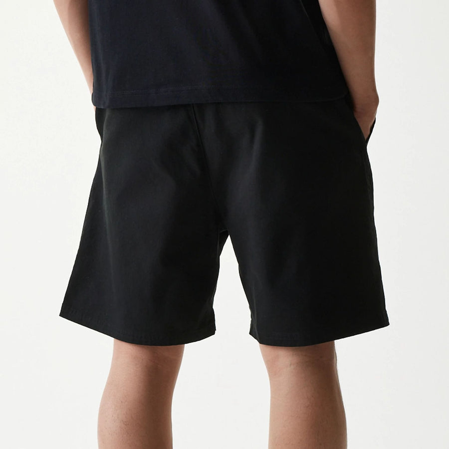 The Male model is wearing New Era Japan Woven Black Shorts 6