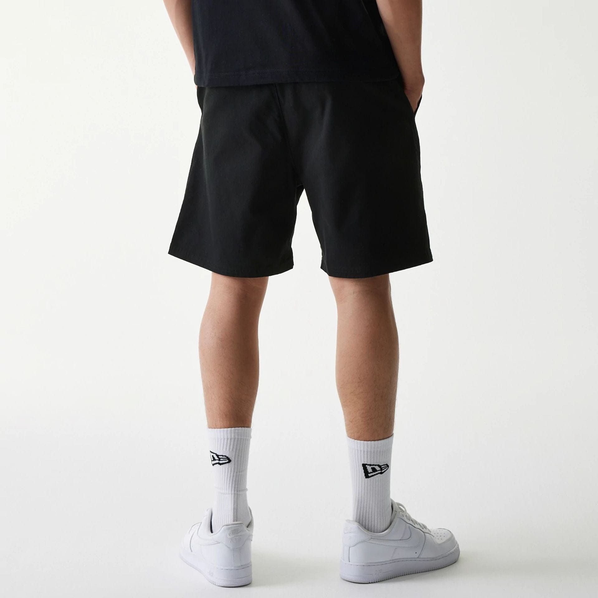 The Male model is wearing New Era Japan Woven Black Shorts 2