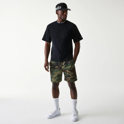 The Male model is wearing New Era Japan Neckband Logo Black T-Shirt 6