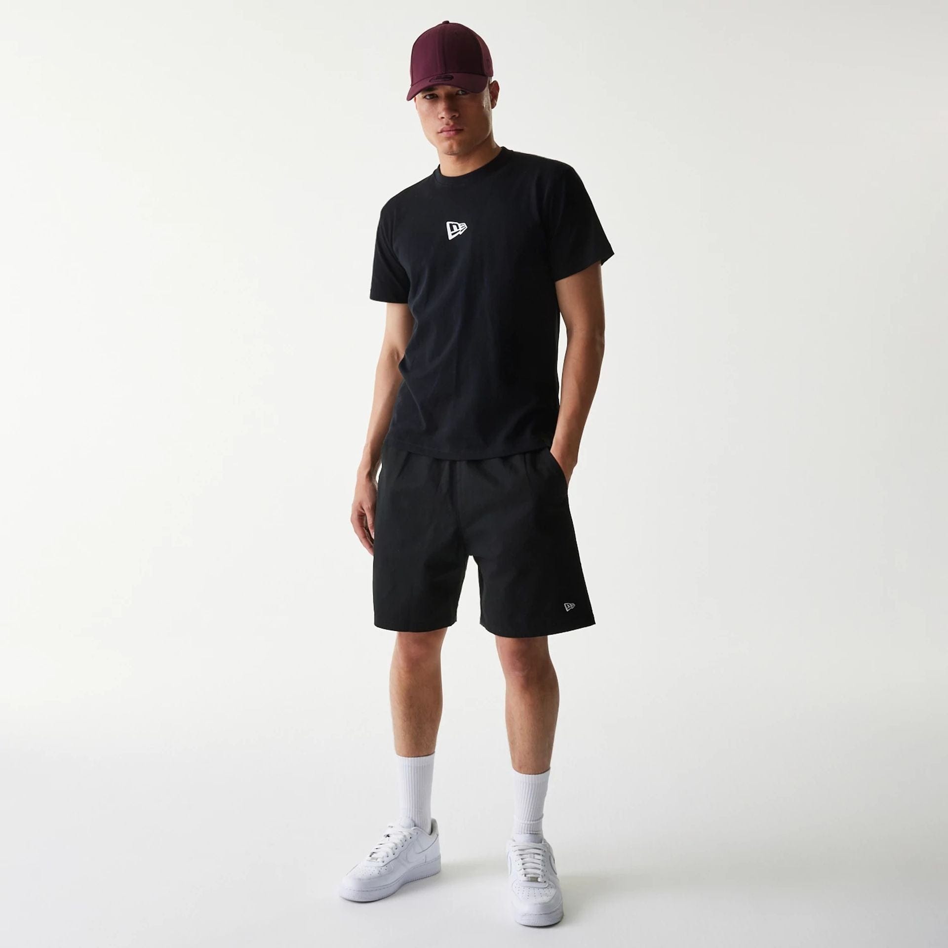 The Male model is wearing New Era Japan Mini Flag Logo Black T-Shirt 6