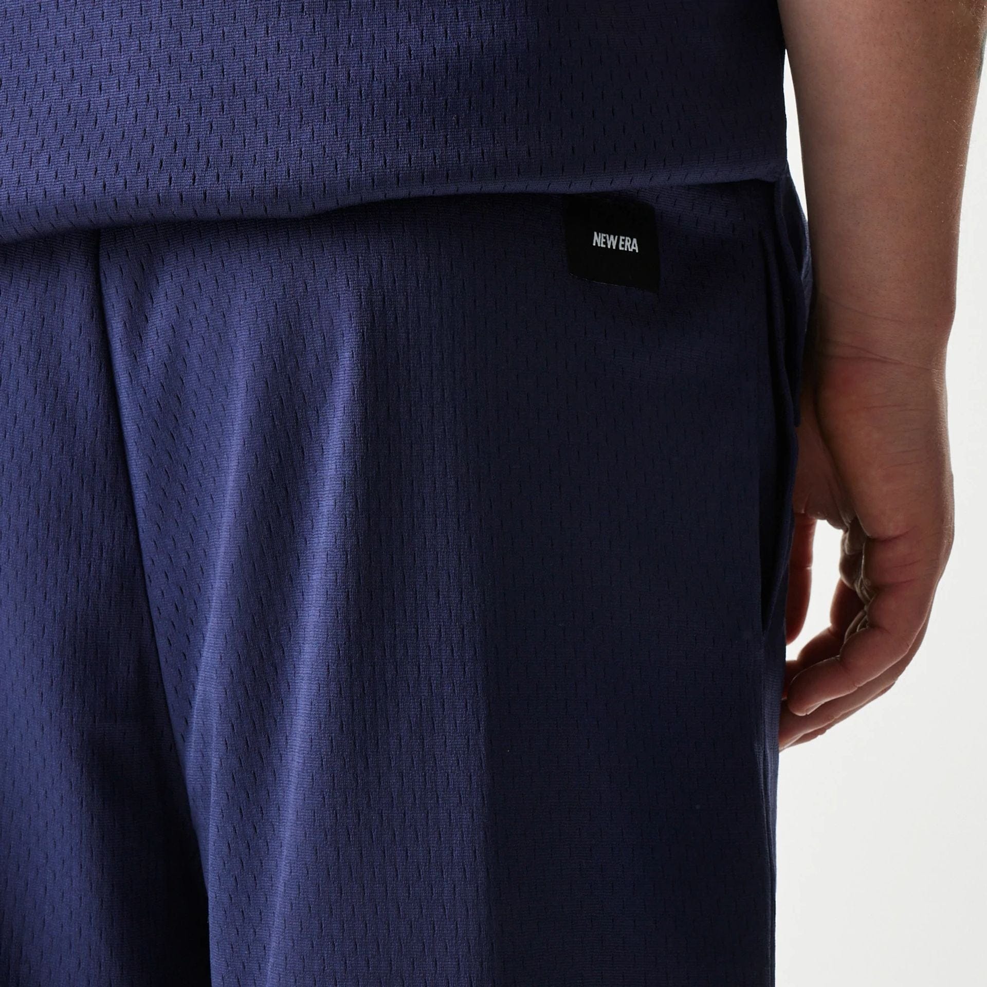 The Male model is wearing New Era Japan Mesh Navy Shorts 4