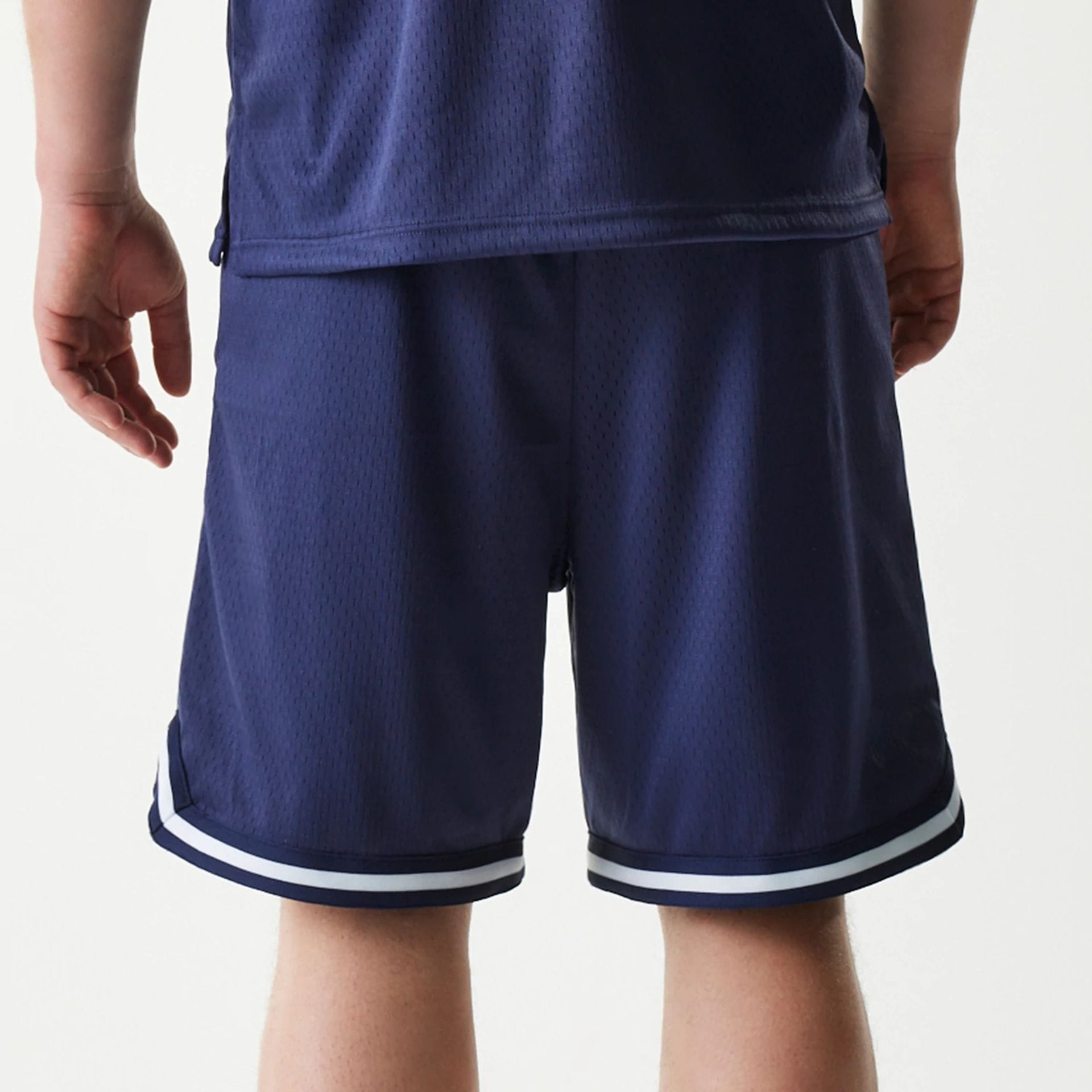 The Male model is wearing New Era Japan Mesh Navy Shorts 5