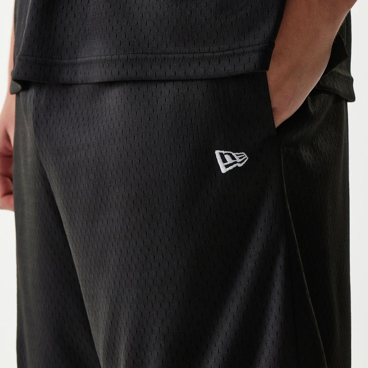 The Male model is wearing New Era Japan Mesh Black Shorts 5