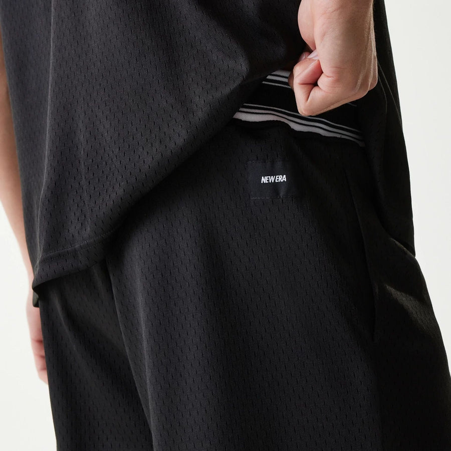 The Male model is wearing New Era Japan Mesh Black Shorts 3