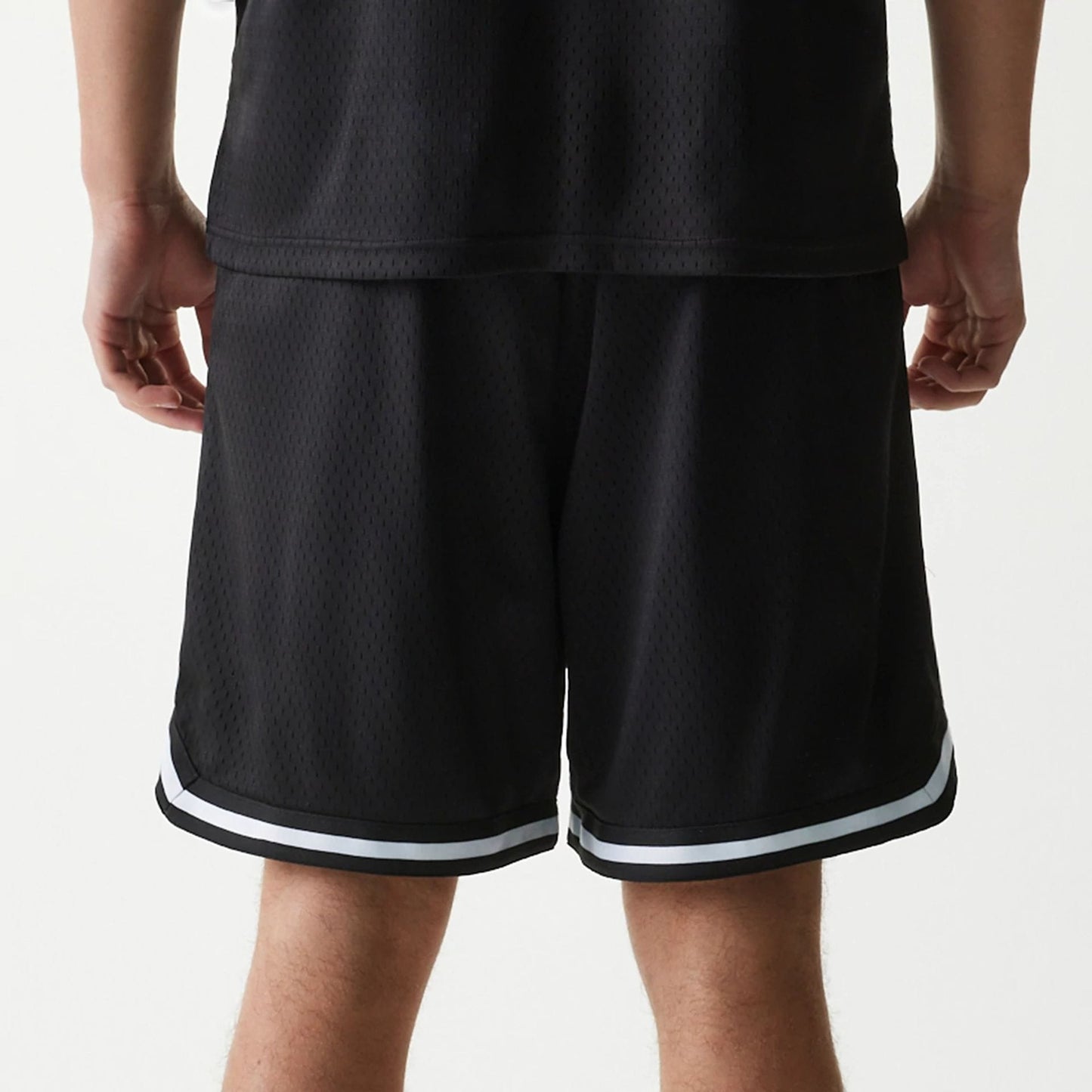 The Male model is wearing New Era Japan Mesh Black Shorts 4