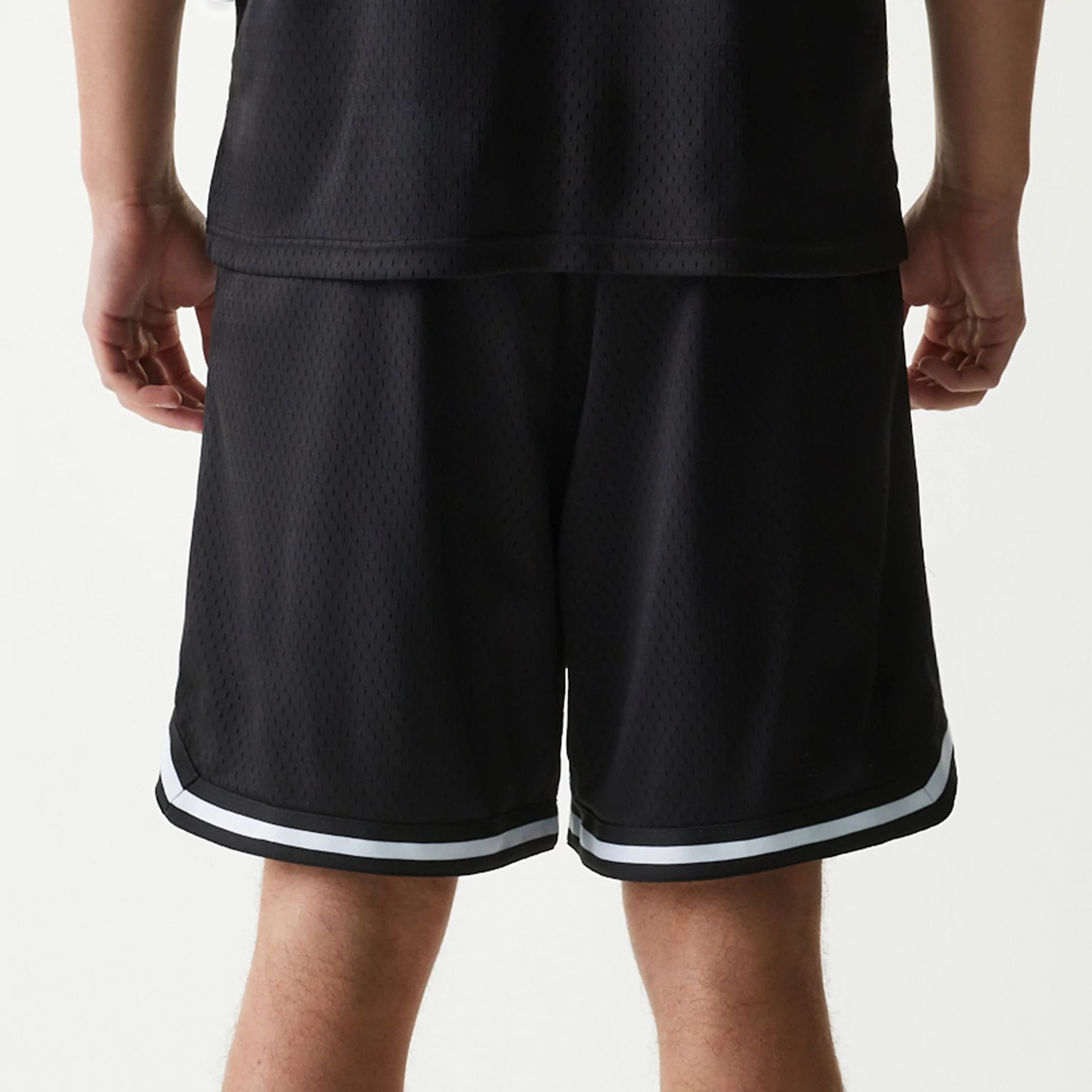 The Male model is wearing New Era Japan Mesh Black Shorts 4