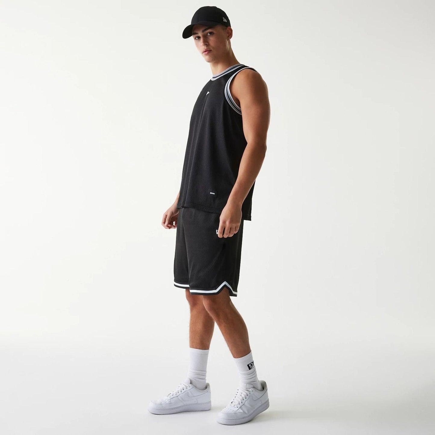 The Male model is wearing New Era Japan Mesh Black Shorts 6