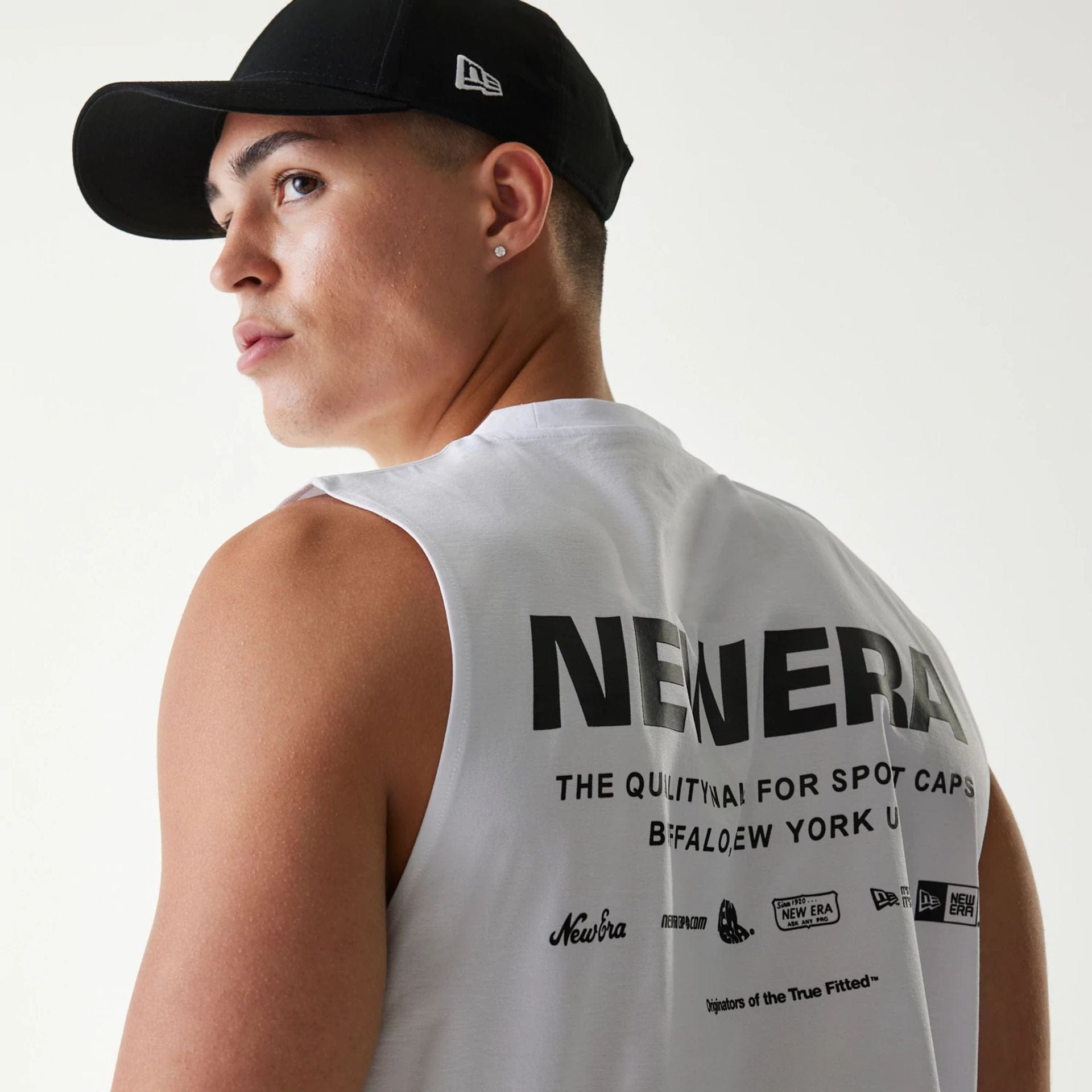 The Male model is wearing New Era Japan White Sleeveless T-Shirt 4
