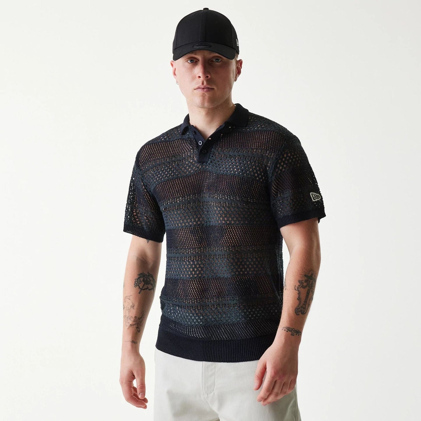 The Male model is wearing New Era Japan Mesh Black Polo T-Shirt 1