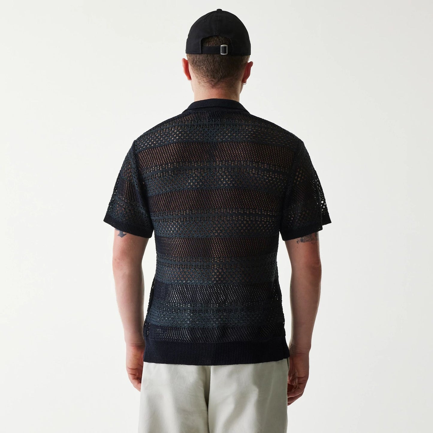 The Male model is wearing New Era Japan Mesh Black Polo T-Shirt 2