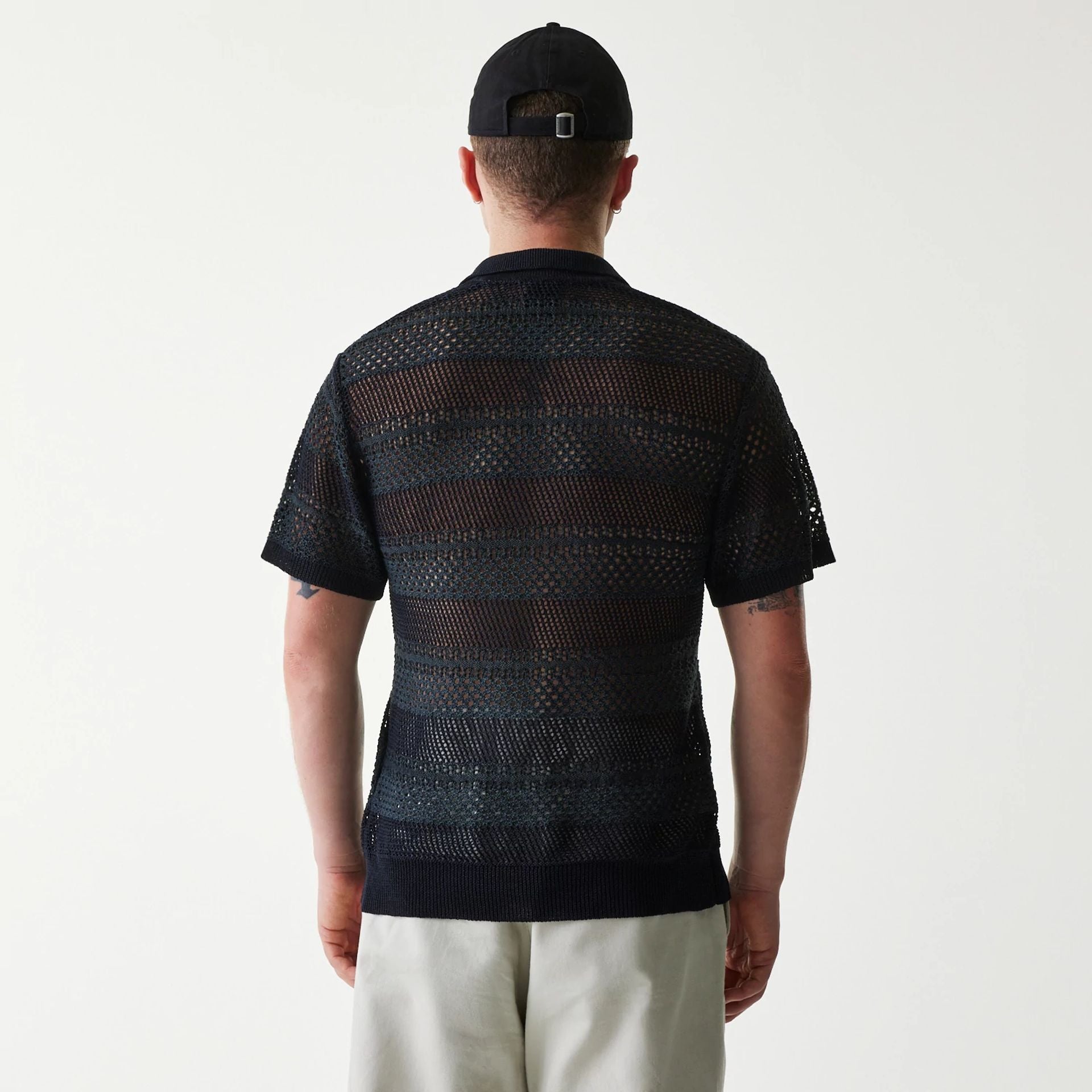The Male model is wearing New Era Japan Mesh Black Polo T-Shirt 2