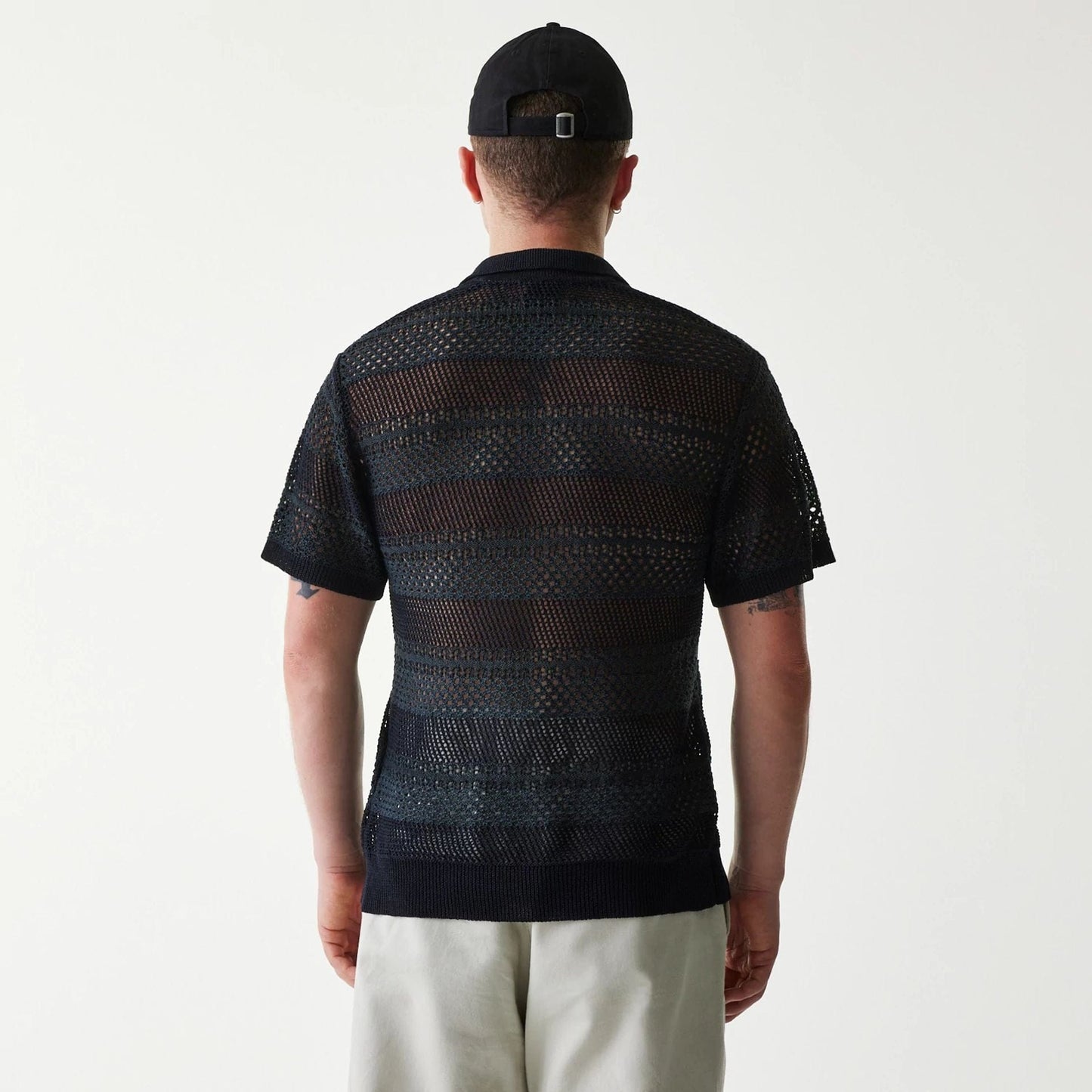The Male model is wearing New Era Japan Mesh Black Polo T-Shirt 2