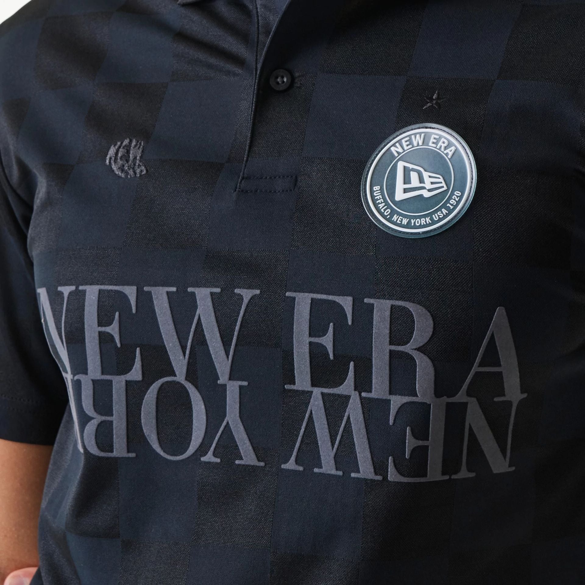 The Male model is wearing New Era Japan Grid Black Polo T-Shirt 3