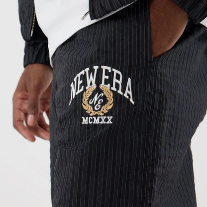 The model is wearing these New Era Street Class straight leg joggers in navy. 2