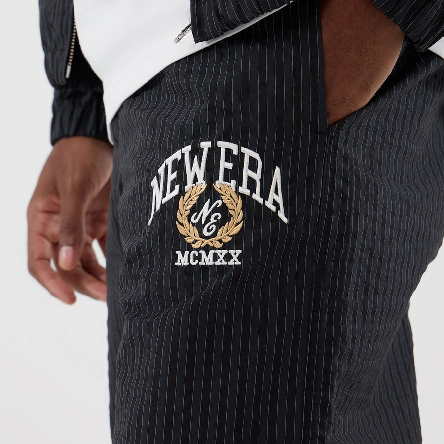 The model is wearing these New Era Street Class straight leg joggers in navy. 2