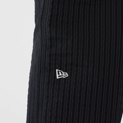 The model is wearing these New Era Street Class straight leg joggers in navy. 3