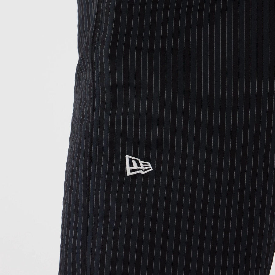 The model is wearing these New Era Street Class straight leg joggers in navy. 3