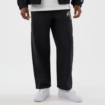 The model is wearing these New Era Street Class straight leg joggers in navy. 8