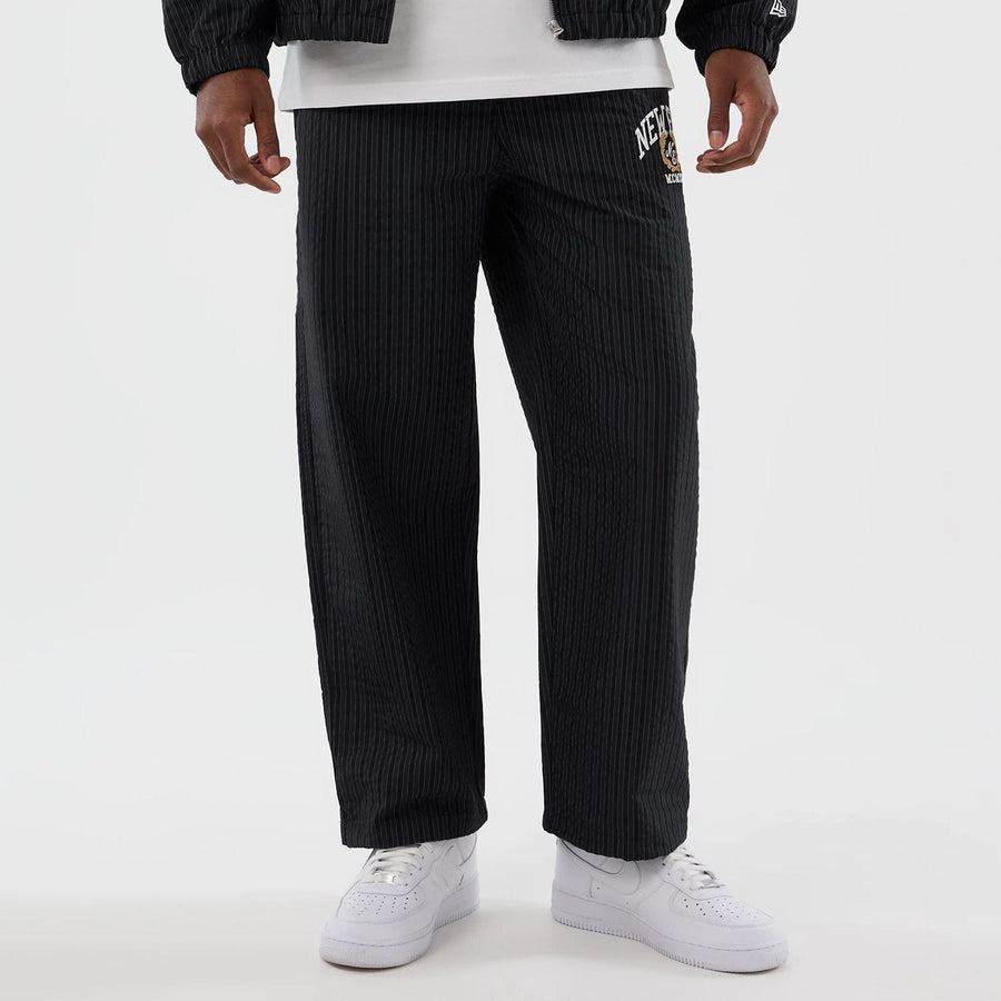 The model is wearing these New Era Street Class straight leg joggers in navy. 8