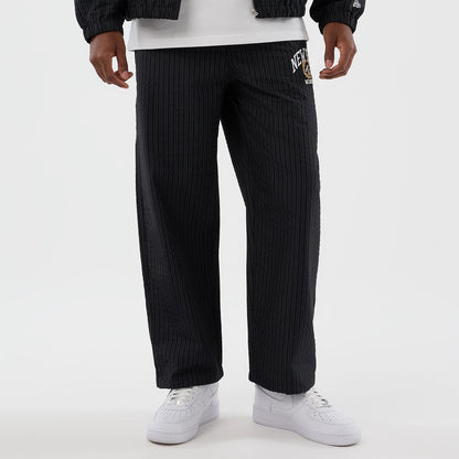 The model is wearing these New Era Street Class straight leg joggers in navy. 8